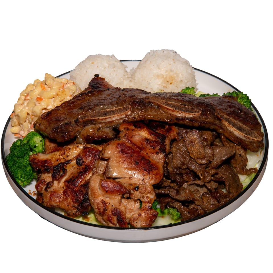 Platter of grilled ribs, chicken, beef, white rice, broccoli, and creamy macaroni salad.