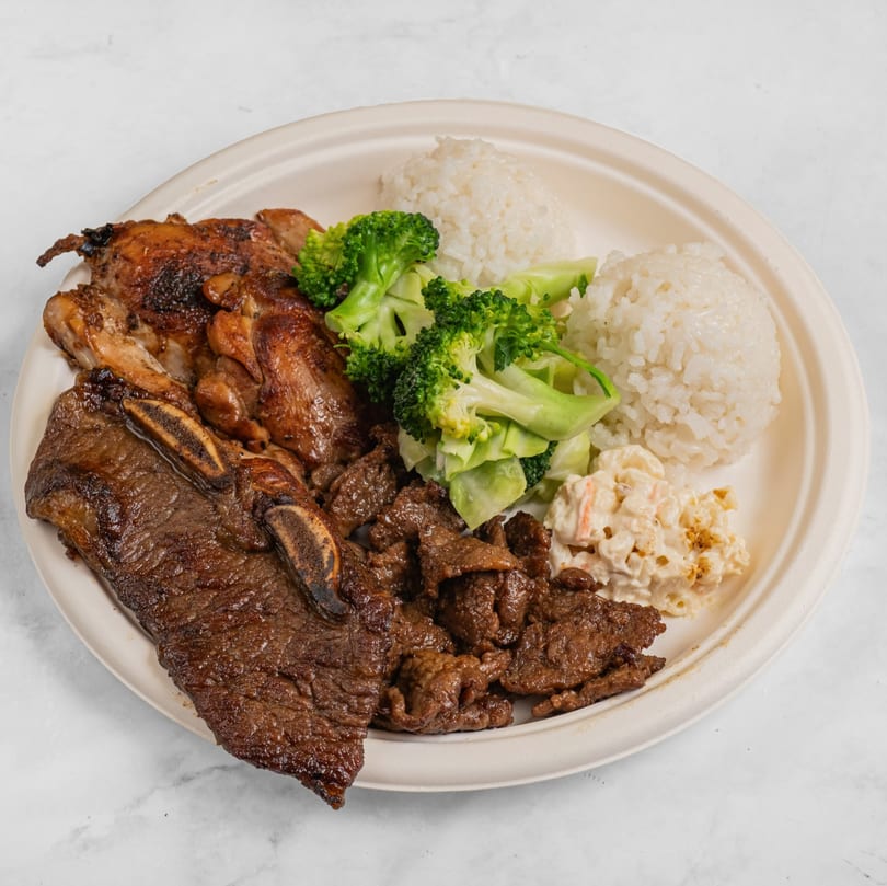 Hawaiian BBQ plate with grilled chicken, short ribs, beef, rice, broccoli, and macaroni salad.