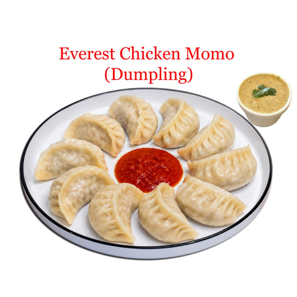 Steamed Everest Chicken Momo dumplings with red chili sauce and a side of green dipping sauce.